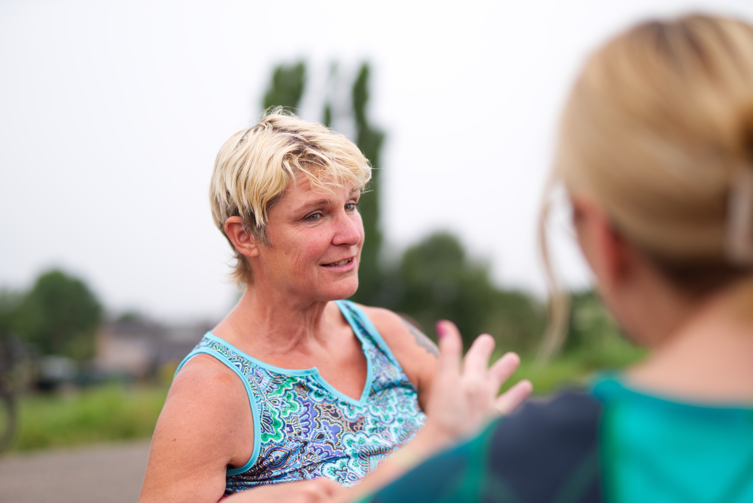 Iris luistert buiten op een bank naar een client